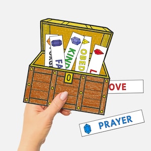May include: A brown treasure chest illustration with a gold interior, held by a hand. The chest contains cards labeled "FAITH", "KIND", "OBED", and "LOVE". Additional cards read "LOVE" and "PRAYER".