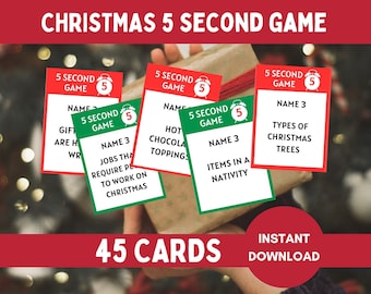 May include: A set of Christmas 5 Second Game cards featuring red and green borders, white backgrounds, and black text. Each card displays a 5 Second Game logo with an alarm clock icon and a prompt such as Types of Christmas Trees or Hot Chocolate Toppings.