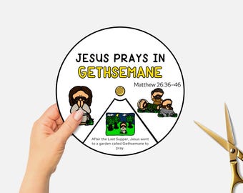 May include: A circular illustration titled "JESUS PRAYS IN GETHSEMANE" with text from Matthew 26:36-46. The image depicts Jesus praying, with additional scenes. A hand holds the illustration, with gold scissors in the background.