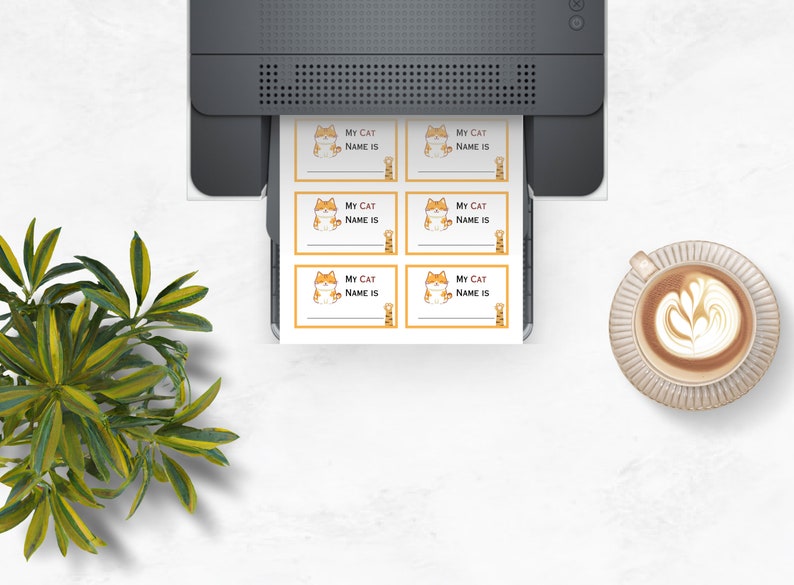 May include: Six printable cat name tags with a cartoon cat illustration. Each tag has the text "My Cat Name Is" printed on it.