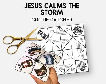 Op de afbeelding: Een witte papieren vouwdoos met de tekst "JESUS CALMS THE STORM" en illustraties. Een gouden schaar ligt naast de vouwdoos. De vouwdoos is gevouwen om de woorden "BOAT", "JESUS", "CALM" en "STORM" te laten zien.