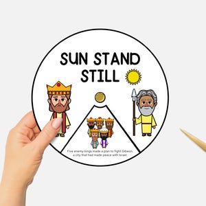 May include: A circular illustration with the text "SUN STAND STILL" and cartoon figures of a king, a man with a spear, and other figures. The illustration is held by a hand, with gold scissors in the background.
