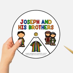May include: A circular educational graphic with the text "JOSEPH AND HIS BROTHERS" in colorful letters. The image depicts cartoon figures and a rainbow-colored coat. A hand holds the graphic, with gold scissors nearby.