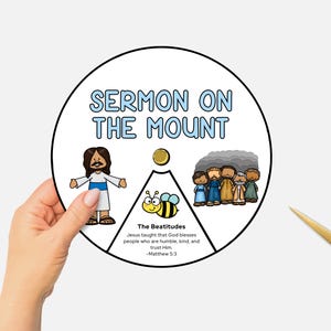 May include: A circular graphic with the text "SERMON ON THE MOUNT" in blue. The graphic includes illustrations of Jesus, a bee, and a group of people. The text "The Beatitudes" and a Bible verse are also included.
