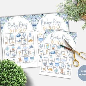 May include: Three printable baby shower bingo cards with blue and gold floral designs. Each card has a 5x5 grid with images of baby items like a rattle, a diaper, a teddy bear, and a pacifier. The text "Baby Boy Bingo" is at the top of each card.
