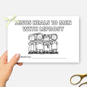 May include: A white card with the text "JESUS HEALS 10 MEN WITH LEPROSY" and a black and white illustration of ten figures. A light green ribbon is attached to the top left corner. Gold scissors are in the bottom right corner.