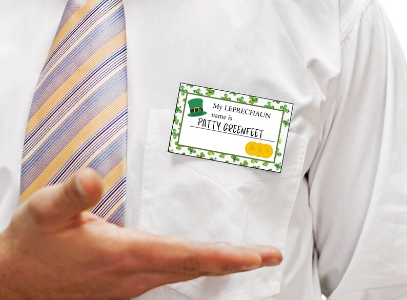 May include: A white shirt with a yellow and blue striped tie. A name tag with green shamrocks and gold coins reads "My Leprechaun name is PATTY GREENFEET".