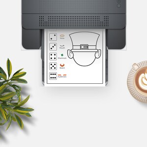 May include: A printable black and white coloring page featuring a leprechaun with a hat, shamrock, beard, nose, mouth, and eyebrows. The page includes a set of dice with different numbers of dots to represent each feature.