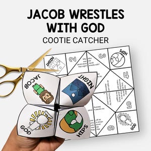 May include: A white paper cootie catcher with the text "JACOB WRESTLES WITH GOD" and illustrations. The cootie catcher is partially folded, with the words "JACOB", "NIGHT", "GOD", and "HIPS" visible. A pair of gold scissors is next to the cootie catcher.