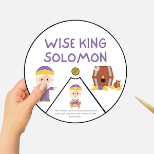 May include: A printable spinning wheel game for kids featuring a cartoon illustration of King Solomon, a chest of gold coins, and the text "WISE KING SOLOMON". The text below the wheel reads "Two women came to King Solomon and both said they were the mother of the same baby."