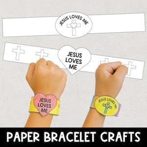Peut inclure: Image d'artisanat de bracelets en papier avec le texte "Jésus m'aime". L'image montre deux mains portant des bracelets colorés. L'un des bracelets est en forme de cœur, l'autre est ovale. Les bracelets ont le texte "Jésus m'aime" et une croix.