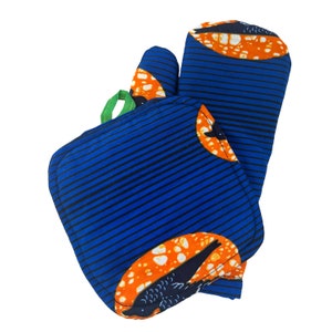 May include: A set of two blue and orange striped oven mitts with a black bird design. The mitts are made of fabric and have a green loop for hanging.