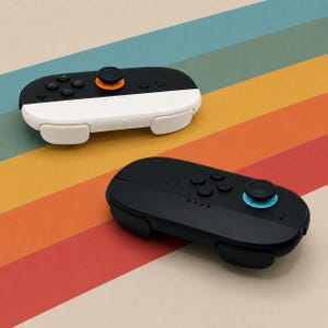 May include: Two wireless game controllers. One controller is split horizontally with a black top and white bottom, featuring an orange joystick base. The second controller is solid black with a bright blue joystick base and four black buttons.