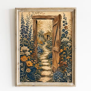 May include: A framed wall art print featuring an open wooden door leading to a stone path through a garden. The scene is surrounded by tall blue delphiniums, white clusters, and orange flowers, all rendered in a detailed, painterly illustration style.