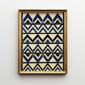 May include: A rectangular wall art print in a gold frame featuring a repeating geometric pattern of blue and black chevron shapes on a cream background. The design consists of horizontal rows of alternating blue and black triangles arranged in a structured, symmetrical layout.