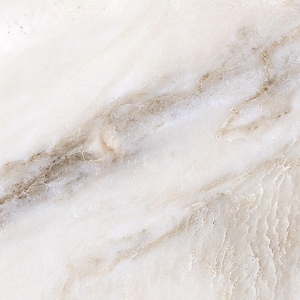 May include: Close-up of a white marble surface with subtle brown and gray veining. The natural stone has a polished appearance, with variations in color and texture. The overall effect is a smooth, elegant, and luxurious look.