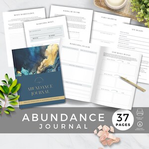 May include: A blue and gold journal with the title "Abundance Journal" printed on the cover. The journal has 37 pages and is designed to help people manifest abundance in their lives. The journal includes prompts for setting goals, identifying money blocks, and visualizing a new reality.