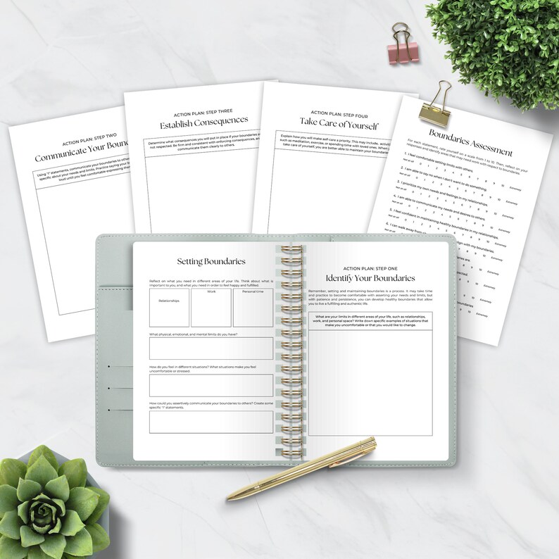 May include: A green and gray spiral bound journal with the title "Setting Boundaries" on the left page and "Identify Your Boundaries" on the right page. The journal is open to a page with a chart for setting boundaries in different areas of life.