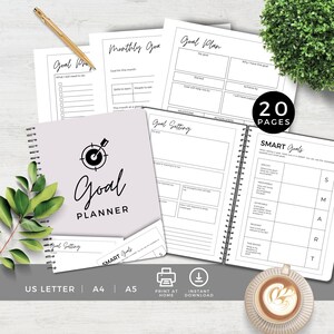 May include: A printable goal planner with a purple cover and a white target with an arrow in the center. The planner has 20 pages and includes sections for monthly goals, goal setting, and SMART goals. The planner is available in US Letter, A4, and A5 sizes.