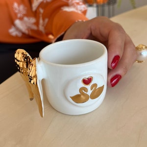 Teacup | Coffee cup | Decorated with an &quot;angel wing & 2 swans&quot; | Handmade from ceramic | With real gold elements | Designer cup