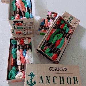 May include: Assortment of colourful embroidery floss spools in boxes labelled "Clark's Anchor Fast Colour Stranded Cotton".