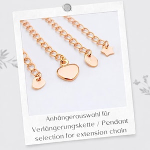 May include: Four rose gold-toned metal extension chains, each featuring a distinct charm at the end: a small heart, a larger heart, a round disc, and a star. The text below reads: Anh&auml;ngerauswahl f&uuml;r Verl&auml;ngerungskette / Pendant selection for extension chain.