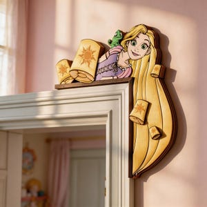 May include: Wooden wall decor featuring a cartoon illustration of a princess with long blonde hair and a green frog. The princess is surrounded by floating lanterns with sun designs. The decor is mounted on a door frame.