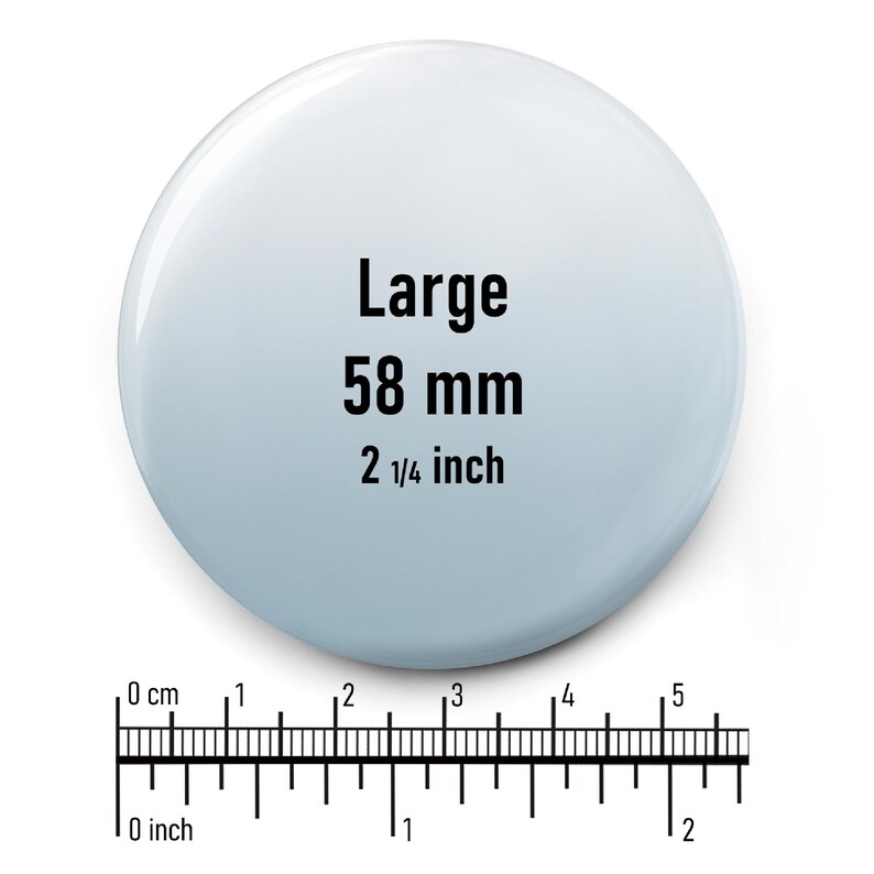 May include: A large, white, round button with the text "Large 58 mm 2 1/4 inch" printed in black.