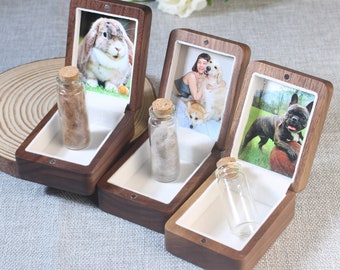 May include: Three wooden boxes with glass vials and photos of pets inside. The boxes are made of dark wood and have a hinged lid. The photos show a rabbit, a woman with two dogs, and a French bulldog.