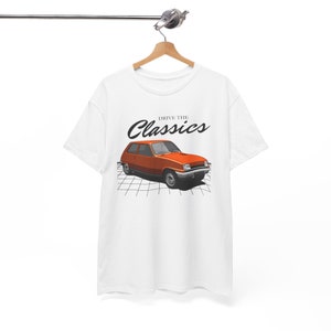 May include: White t-shirt with a graphic of an orange vintage car and the text "Drive the Classics" printed on the front.