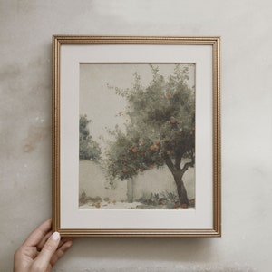 Puede incluir: Una pintura de acuarela enmarcada de un &aacute;rbol con fruta naranja. El &aacute;rbol est&aacute; en un jard&iacute;n con una pared blanca en el fondo. La pintura est&aacute; en un marco dorado.