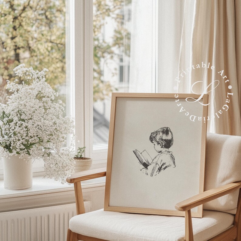 May include: A framed black and white illustration of a child reading a book. The illustration is on a beige background and the frame is a light wood color.