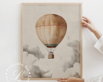 May include: A framed print featuring a vintage-style hot air balloon illustration. The balloon is tan with red stripes, floating above gray watercolor clouds. The artwork is in a light brown wooden frame.