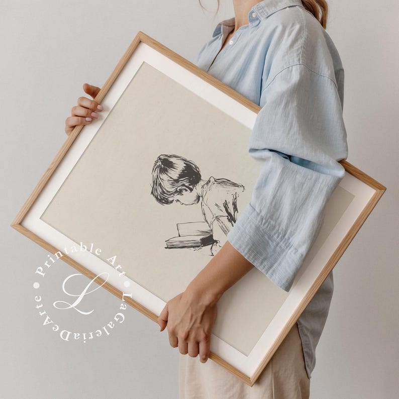 May include: A black and white illustration of a child reading a book. The illustration is printed on a beige background and framed in a light wood frame.
