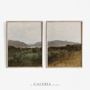 May include: Two framed landscape paintings with a muted color palette. The paintings depict a view of a valley with rolling hills and a river in the distance. The paintings are in a light wood frame.