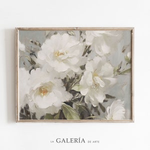 May include: A framed painting of white flowers with green leaves on a light blue background. The painting is in a light wood frame.