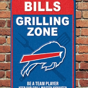 May include: Blue and red metal sign with the text "Bills Grilling Zone" and a blue buffalo logo. The text "Be a team player keep our grill master hydrated" is at the bottom of the sign.