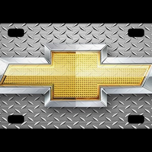 May include: A silver and gold Chevrolet logo on a silver diamond plate background. The logo is a stylized bowtie with a gold center.