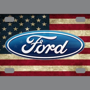 May include: A blue and white Ford logo on a red, white, and blue American flag background. The flag has a distressed, vintage look.