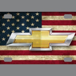 May include: A vintage-style American flag license plate featuring a gold and silver Chevrolet logo.