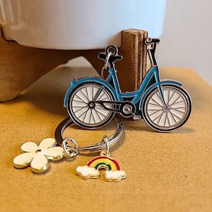 May include: A set of three ceramic mugs with a speckled, matte finish. Each mug is a different colour: light blue, cream, and grey. The mugs have a simple, modern design and a comfortable handle.