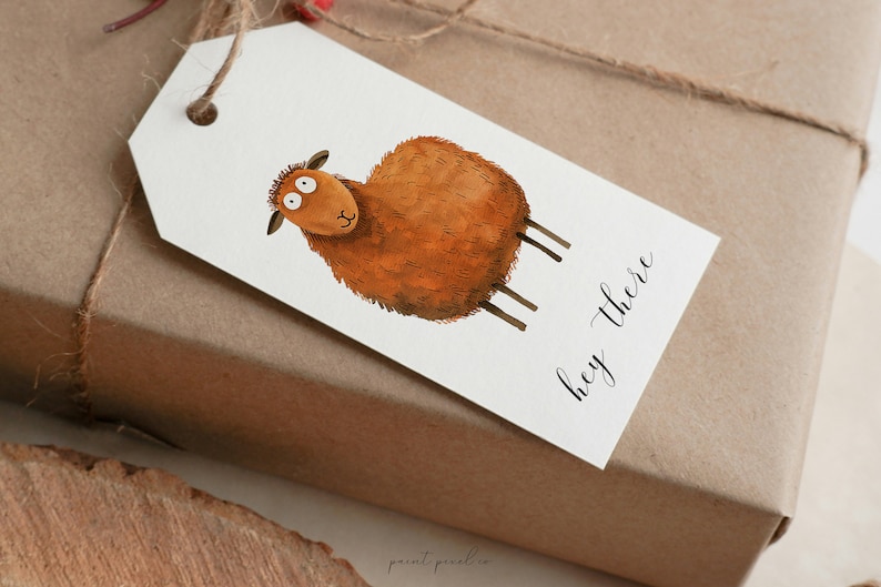 May include: A white gift tag with a brown sheep illustration and the text "hey there" in black calligraphy.