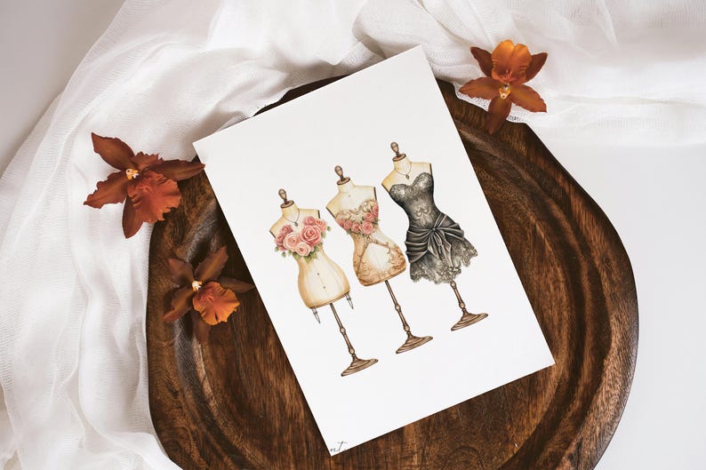 May include: A watercolor illustration of three vintage dress forms with floral details. The dress forms are wearing different styles of dresses, including a black lace dress, a beige dress with floral details, and a white dress with floral details.