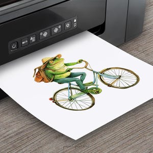 May include: A green frog wearing a brown hat and backpack rides a blue bicycle with a brown basket. The frog is smiling and holding the handlebars. The bicycle has a brown seat and brown wheels.