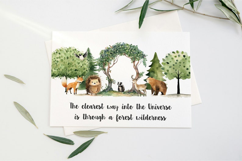 Peut inclure: Une illustration aquarelle d'une sc&egrave;ne de for&ecirc;t avec un renard, un h&eacute;risson, un blaireau, un cerf et un ours. Le texte "The clearest way into the Universe is through a forest wilderness" est &eacute;crit sous les animaux.