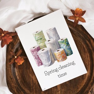 May include: A watercolour illustration of a stack of colourful paper towel rolls with the text "Spring cleaning time".