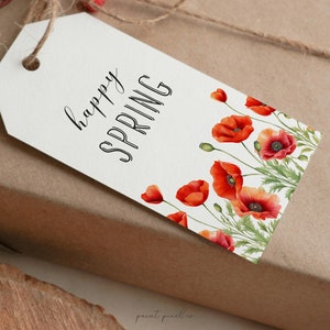 May include: White gift tag with the text "happy spring" in black cursive lettering. The tag is decorated with a border of red poppy flowers.
