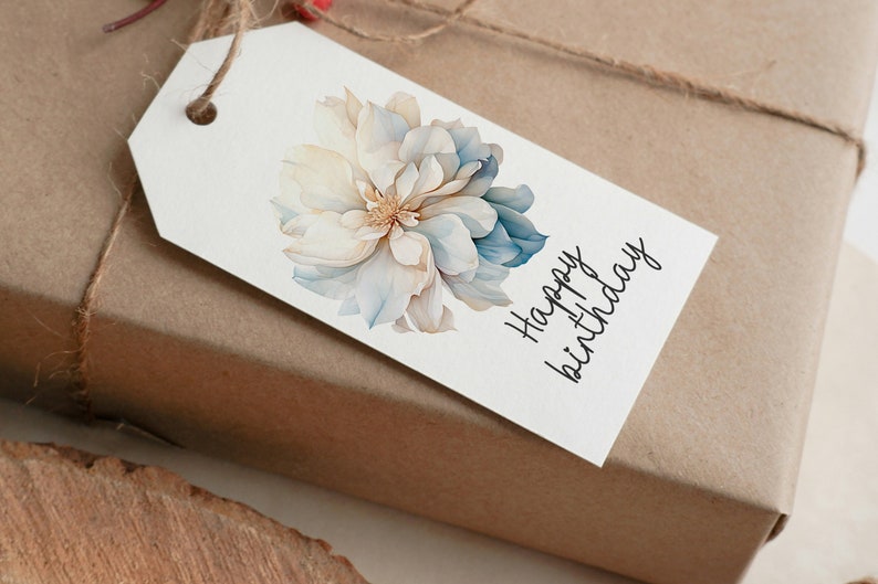 May include: A white gift tag with a blue and white watercolor flower and the text "Happy birthday" in black cursive.
