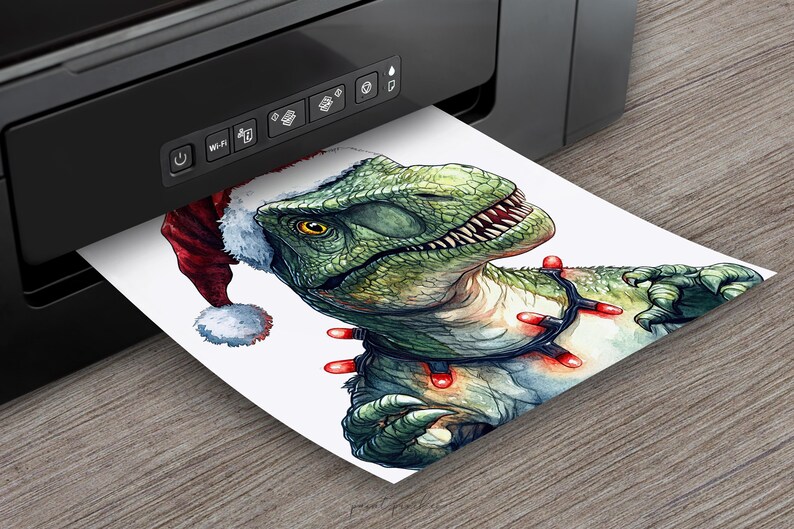 May include: A green dinosaur wearing a red and white Santa hat and a string of red Christmas lights around its neck. The dinosaur is printed on a white sheet of paper coming out of a black printer.