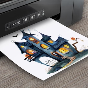 May include: A printable design featuring a watercolor illustration of a spooky blue and gray haunted house with orange pumpkins and a jack-o-lantern. The house has glowing windows and a black door. The design is printed from a black printer.